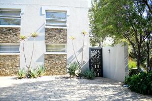 a house with a gate and plants in front of it at 20 ON WOODLANDS in Johannesburg