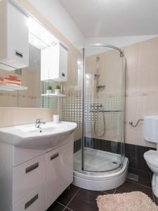 a bathroom with a sink and a shower at Apartments Olea in Poreč