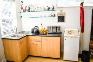 a small kitchen with a sink and a refrigerator at 20 ON WOODLANDS in Johannesburg