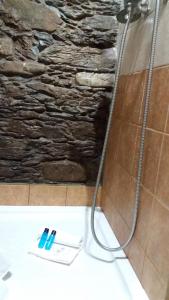 a shower with a toothbrush on the floor of a bathroom at Casa do Alto in Penacova