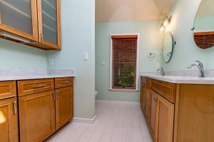 a bathroom with two sinks and a mirror at Sunset Royale in Duck +31 photos