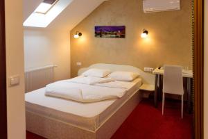 a small bedroom with a bed and a desk at Equinoxe Royal Reghin in Reghin +61 photos