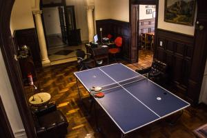 a ping pong table in the middle of a room at Be King Hostel in Rosario