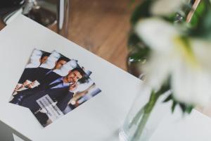 a picture of a groom in a suit on a table at P&O Serviced Apartments FABRYCZNA in Warsaw