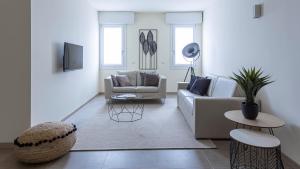a living room with a couch and a table at Erïk Langer Pedrocchi Suites in Padova