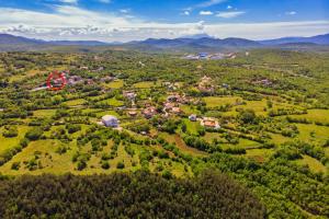 an aerial view of a small town in the hills at Rooms Marijana in Trilj