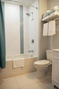 a bathroom with a tub and a toilet and a sink at Valley View in Lake Cowichan +18 photos