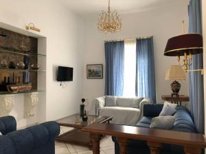a living room with a couch and a table at Villa Andros Époque in Andros