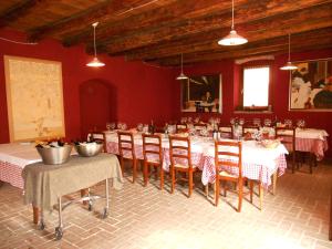 a dining room with red walls and tables and chairs at Camping Bella Italia in Peschiera del Garda