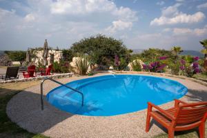 a swimming pool with a bench and a chair next to it at El Macehual in San Miguel de Allende +37 photos