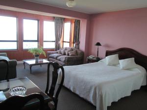 Postel nebo postele na pokoji v ubytování Hotel Apart Colón