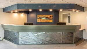 a lobby of a hospital with a green counter at Bridgewater Hotel, Trademark Collection by Wyndham in Fairbanks