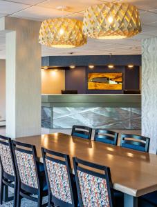 a conference room with a wooden table and chairs at Bridgewater Hotel, Trademark Collection by Wyndham in Fairbanks