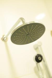 a shower with a black shower head at Nadias Hotel Cenang Langkawi in Pantai Cenang