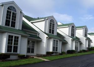 a row of white houses with green roofs at The Townhouses in Branson