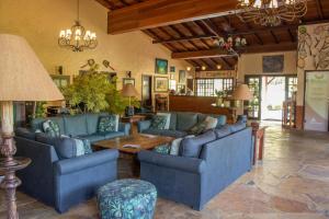 a living room with blue couches and a table at Bomtempo Itaipava Hotel by Castelo Itaipava in Itaipava +110 photos
