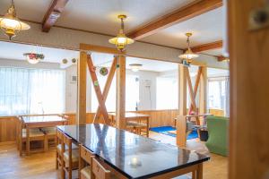 a dining room with a table and some chairs at Daisen Backpackers in Hoki