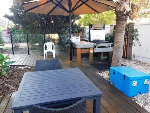
a patio area with a table and chairs at Casablanca Beachfront Apartments in Caloundra
