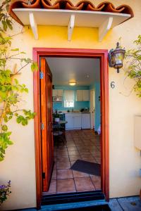 a door leading into a kitchen with a dining room at Leucadia Beach Inn in Encinitas