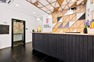 a bar at a pizza hotel with a sign on the wall at Rica Hotel Usj in Subang Jaya