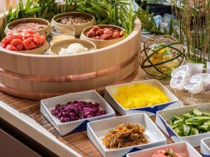a table topped with bowls of different types of food at Premier Hotel-CABIN-Sapporo in Sapporo