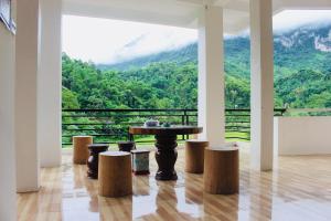 a room with a table and stools with a view at Ba Be Legend Hotel in Ba Be18