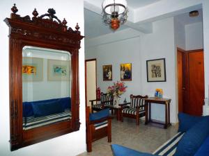 a living room with a mirror and a table with chairs at Aiolos House in Skiathos