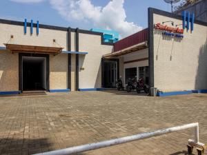 a building with motorcycles parked outside of it at RedDoorz near Goa Panggung in Pangandaran