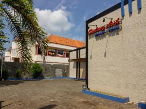 a building with a sign on the side of it at RedDoorz near Goa Panggung in Pangandaran