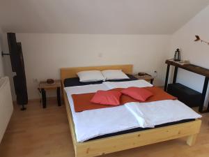 a bed with two pillows on it in a room at Guesthouse S in Luče