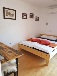 a bedroom with a bed and a desk at Guesthouse S in Luče