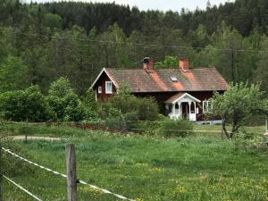 a house in the middle of a field at Yxefall Norrgården in Kisa