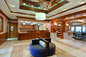 a large lobby with a waiting area and a chair at Hyatt House Dallas Addison in Addison