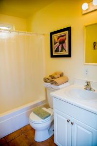 a bathroom with a toilet and a sink at Leucadia Beach Inn in Encinitas