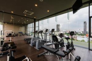 a gym with treadmills and cardio machines in a building at The Residence on Thonglor by UHG in Bangkok +75 photos