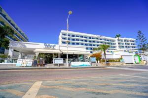 an empty street in front of a large building at Melini Hotel Suites in Protaras