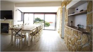 a dining room with a long table and chairs at Villa Ruzanna in Mandelieu-La Napoule