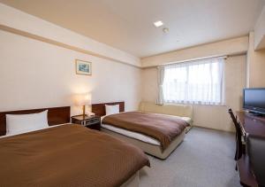 Postel nebo postele na pokoji v ubytování Komoro Grand Castle Hotel + 20 fotografií