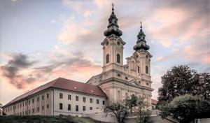 a church with two towers on top of a building at City Center Apartment II in Nitra