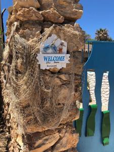 a rock wall with a sign on it at I Dammusi del Blu Green in Lampedusa