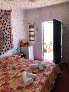 a bedroom with a bed with towels on it at I Dammusi del Blu Green in Lampedusa