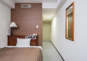 Postel nebo postele na pokoji v ubytování Komoro Grand Castle Hotel