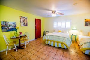 a bedroom with a bed and a table at Leucadia Beach Inn in Encinitas