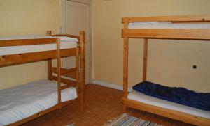 a room with two bunk beds and a hallway at Cornelia in Somme-Leuze