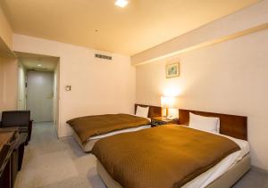 Postel nebo postele na pokoji v ubytování Komoro Grand Castle Hotel