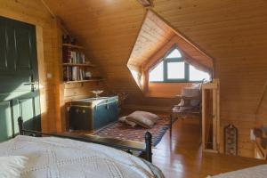 a room with a attic with a bed and a window at CHALET REGINA in Paradhísion