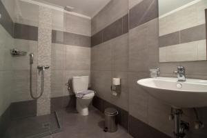 a bathroom with a sink and a toilet at Cosmopolit in Athens