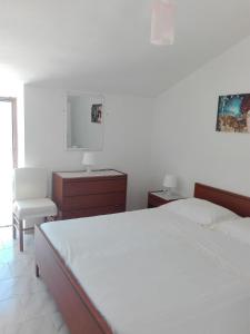 a bedroom with a bed and a desk and a chair at Palinuro Villa Bellavista in Palinuro
