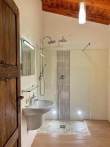a bathroom with a sink and a shower with a shower at Abruzzo Borgo in Alanno