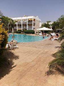 a large swimming pool with people in a resort at רויאל פארק1 in Eilat